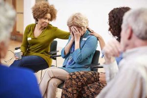 group participates in therapy at treatment center